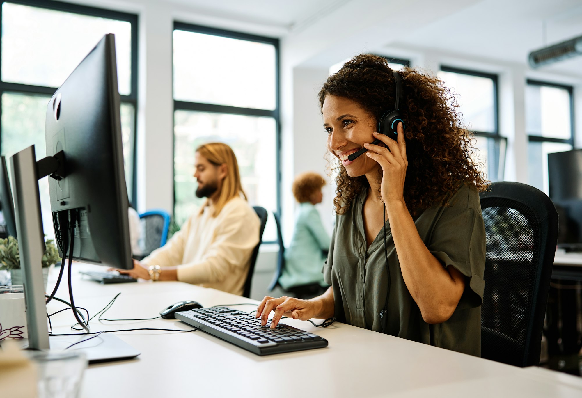 Woman working with computer in a coworking call center